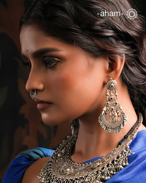 A classic design from Rajasthan's tribal heritage, these Tribal Silver Bali Earrings feature beautiful cutwork silver leaves at the bottom. 
