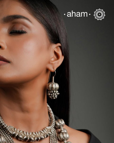 Stunning pumpkin bead earring with ghungroos at the bottom. Handcrafted in silver, this unique piece is a must-have for those who cherish tribal heritage jewellery with a story to tell.
