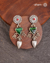 Old world pieces carry a distinct allure—timeless and exquisite, perfect as heirlooms. These tribal silver earrings featuring vibrant glass accents offer a stunning addition to your collection. The rich colors bring a striking contrast to any ensemble. Please note that as these earrings are handcrafted from assorted vintage components, slight variations between the pair are to be expected.