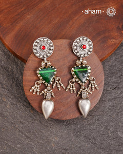 Old world pieces carry a distinct allure—timeless and exquisite, perfect as heirlooms. These tribal silver earrings featuring vibrant glass accents offer a stunning addition to your collection. The rich colors bring a striking contrast to any ensemble. Please note that as these earrings are handcrafted from assorted vintage components, slight variations between the pair are to be expected.