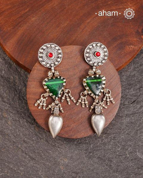 Old world pieces carry a distinct allure—timeless and exquisite, perfect as heirlooms. These tribal silver earrings featuring vibrant glass accents offer a stunning addition to your collection. The rich colors bring a striking contrast to any ensemble. Please note that as these earrings are handcrafted from assorted vintage components, slight variations between the pair are to be expected.