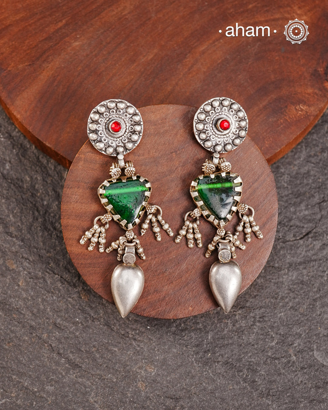 Old world pieces carry a distinct allure—timeless and exquisite, perfect as heirlooms. These tribal silver earrings featuring vibrant glass accents offer a stunning addition to your collection. The rich colors bring a striking contrast to any ensemble. Please note that as these earrings are handcrafted from assorted vintage components, slight variations between the pair are to be expected.