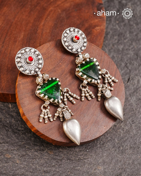 Old world pieces carry a distinct allure—timeless and exquisite, perfect as heirlooms. These tribal silver earrings featuring vibrant glass accents offer a stunning addition to your collection. The rich colors bring a striking contrast to any ensemble. Please note that as these earrings are handcrafted from assorted vintage components, slight variations between the pair are to be expected.