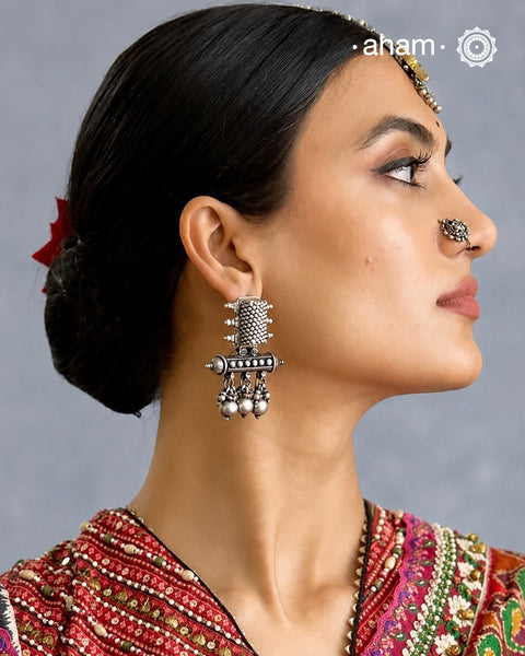 An exquisite fusion of the past and present, these Vintage Tribal Earrings unite two stunning silver pieces. The top and bottom features vintage amulets steeped in history with ghungroos. Handcrafted in silver, this unique piece is a must-have for those who cherish tribal heritage jewellery with a story to tell.