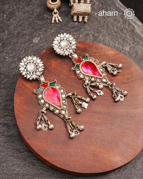 Old world pieces carry a distinct allure—timeless and exquisite, perfect as heirlooms. These tribal silver earrings featuring vibrant glass accents offer a stunning addition to your collection. The rich colors bring a striking contrast to any ensemble. Please note that as these earrings are handcrafted from assorted vintage components, slight variations between the pair are to be expected.
