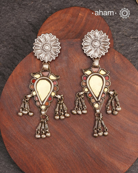 Old world pieces carry a distinct allure—timeless and exquisite, perfect as heirlooms. These tribal silver earrings featuring vibrant glass accents offer a stunning addition to your collection. The rich colors bring a striking contrast to any ensemble. Please note that as these earrings are handcrafted from assorted vintage components, slight variations between the pair are to be expected.