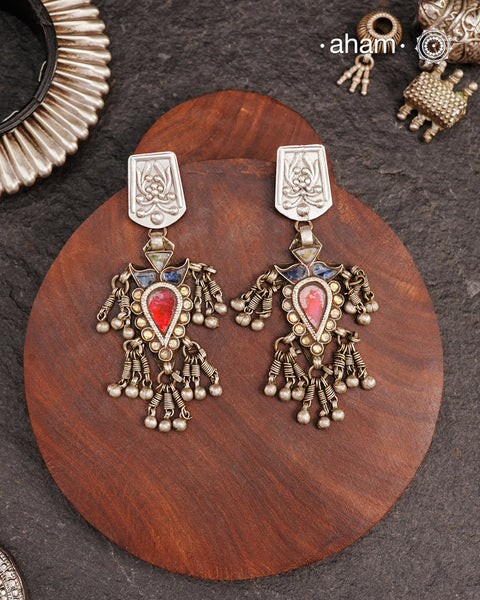 Old world pieces carry a distinct allure—timeless and exquisite, perfect as heirlooms. These tribal silver earrings featuring vibrant glass accents offer a stunning addition to your collection. The rich colors bring a striking contrast to any ensemble. Please note that as these earrings are handcrafted from assorted vintage components, slight variations between the pair are to be expected.