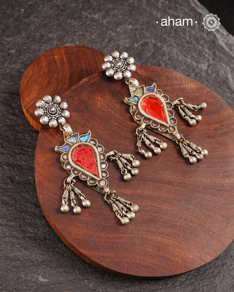 Old world pieces carry a distinct allure—timeless and exquisite, perfect as heirlooms. These tribal silver earrings featuring vibrant glass accents offer a stunning addition to your collection. The rich colors bring a striking contrast to any ensemble. Please note that as these earrings are handcrafted from assorted vintage components, slight variations between the pair are to be expected.