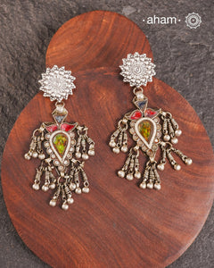 Old world pieces carry a distinct allure—timeless and exquisite, perfect as heirlooms. These tribal silver earrings featuring vibrant glass accents offer a stunning addition to your collection. The rich colors bring a striking contrast to any ensemble. Please note that as these earrings are handcrafted from assorted vintage components, slight variations between the pair are to be expected.