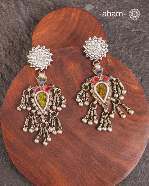 Old world pieces carry a distinct allure—timeless and exquisite, perfect as heirlooms. These tribal silver earrings featuring vibrant glass accents offer a stunning addition to your collection. The rich colors bring a striking contrast to any ensemble. Please note that as these earrings are handcrafted from assorted vintage components, slight variations between the pair are to be expected.