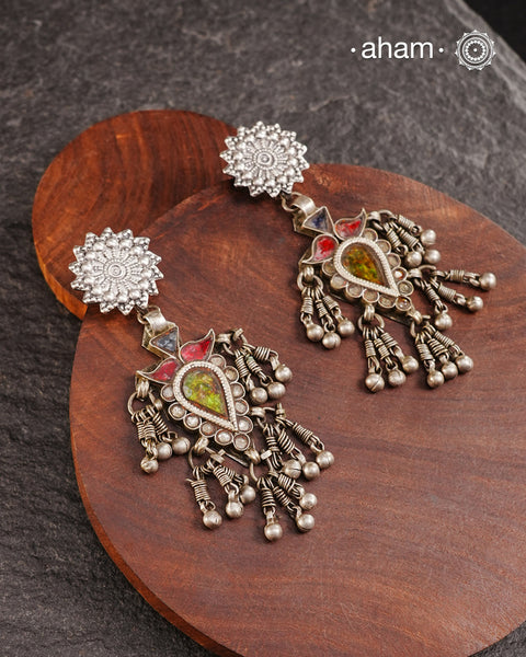 Old world pieces carry a distinct allure—timeless and exquisite, perfect as heirlooms. These tribal silver earrings featuring vibrant glass accents offer a stunning addition to your collection. The rich colors bring a striking contrast to any ensemble. Please note that as these earrings are handcrafted from assorted vintage components, slight variations between the pair are to be expected.