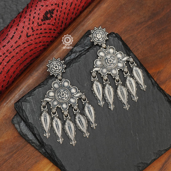 Shivneri chandelier earrings, handcrafted in 92.5 sterling silver with flower and fish motifs. Looks great with both ethnic and western outfits. Crafted by master artisans from Kolhapur, these earrings are so light weight and comfortable to wear all day long. 