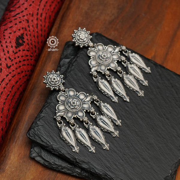 Shivneri chandelier earrings, handcrafted in 92.5 sterling silver with flower and fish motifs. Looks great with both ethnic and western outfits. Crafted by master artisans from Kolhapur, these earrings are so light weight and comfortable to wear all day long. 