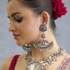 Shivneri chandbali statement earrings. Handcrafted in 92.5 sterling silver with rani pink peacock motifs resting on a beautiful crescent. Perfect for special occasions and gifting.