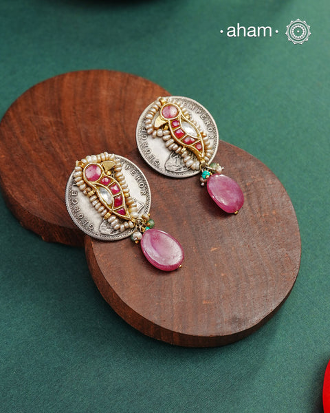 Handcrafted Noori two tone coin earrings in silver with pink semi precious stone. With beautiful bird motif and embellished cultured pearls.&nbsp;Style this up with your favourite ethnic or fusion outfit.