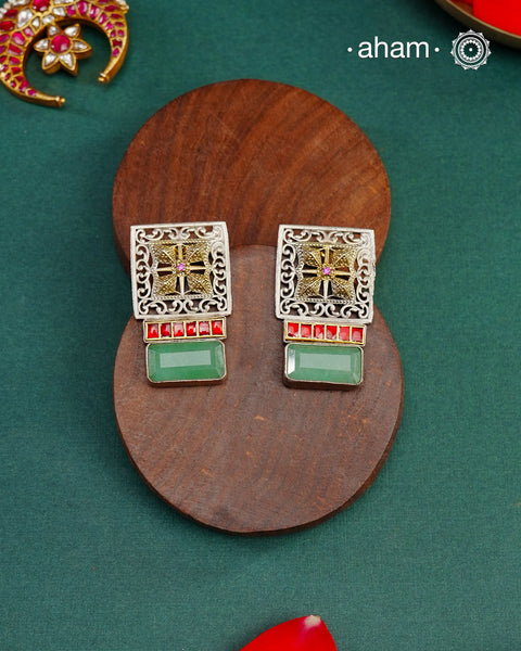 Noori dual tone silver green stone earrings. Handcrafted in 92.5 sterling silver with red kundan setting.&nbsp;Style this elegant earrings with your favourite ethnic or fusion outfits to complete the look.