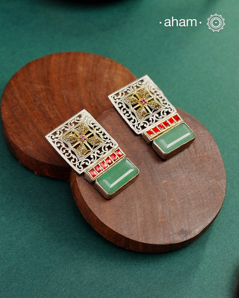 Noori dual tone silver green stone earrings. Handcrafted in 92.5 sterling silver with red kundan setting.&nbsp;Style this elegant earrings with your favourite ethnic or fusion outfits to complete the look.