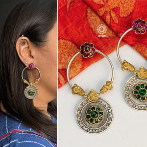 Noori dual tone earrings with delicate peacock motifs and beautiful maroon and green flowers. Handcrafted in 92.5 sterling silver. Style this up with your favourite ethnic or fusion outfit.