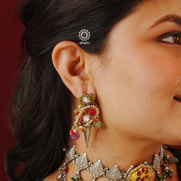 Handcrafted noori two tone earrings in 92.5 sterling silver. Beautiful parrot motif with kundan work, semi precious stones and cultured pearls. Style this up with your favourite ethnic or fusion outfit.