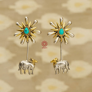 Noori two tone earrings handcrafted in 92.5 sterling silver with Kamadhenu motif, a hint of turquoise and embellished cultured pearls. Style this up with your favourite ethnic or fusion outfit.