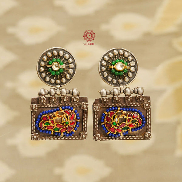 Noori two tone handcrafted earrings in 92.5 sterling silver with dual tones. Eclectic mix of elements with beautiful bird motifs, kundan and coloured beads. Style this up with your favourite ethnic or fusion outfit.