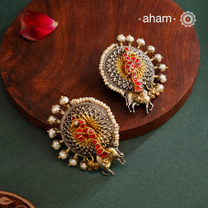 Noori peacock two tone statement studs in 92.5 sterling silver. Handcrafted earrings with beautiful kundan peacock and a detailed cow motifs. Style this up with your favourite ethnic or fusion outfit.