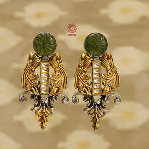 Elevate your style with our Noori Two Tone Silver Earrings. Inspired by art deco, these earrings feature beautiful peacocks on each side for an elegant touch of Indian culture. Crafted with silver and gold polish, these earrings are sure to add a touch of glamour to any outfit.