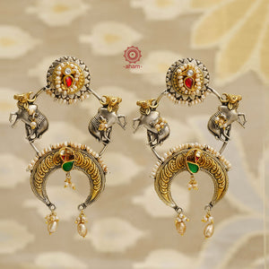 Upgrade your accessory game with Noori's playful and eye-catching Two Tone Silver Earrings. These fun and bold cow earrings will make a statement wherever you go. Crafted with 92.5 silver in a unique silver and gold dual tone, they are finished with delicate pearls and kundan highlights for added elegance. Elevate any outfit with these quirky earrings.