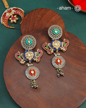Noori statement silver two tone earrings with shades of silver and gold. One of a kind piece, handcrafted with beautiful&nbsp;bird motif and semi precious stones.&nbsp;Style this up with your favourite ethnic or fusion outfit.