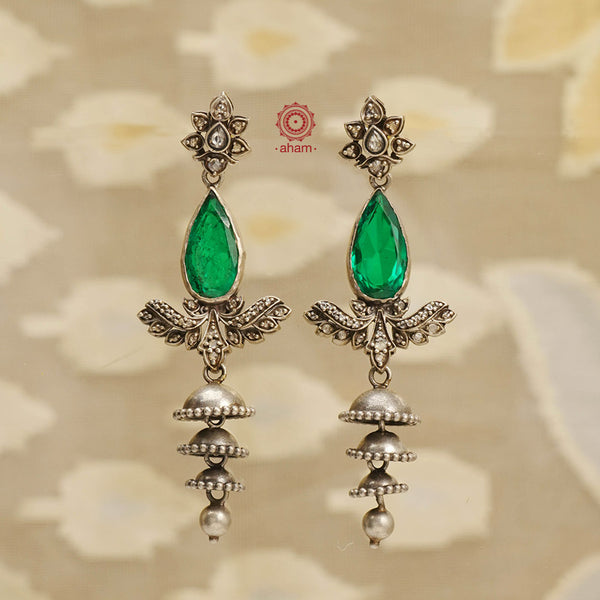 Expertly crafted for the festive season, our Festive Silver Jhumkies are an elegant addition to any outfit. These chandelier earrings feature multiple jhumkies and bright green faceted stone adding a touch of glamour to your look. Perfect for any occasion, these jhumkies are the perfect blend of tradition and style. 