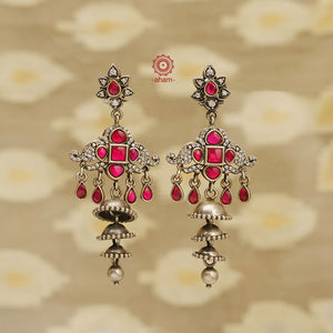Expertly crafted for the festive season, our Festive Silver Jhumkies are an elegant addition to any outfit. These chandelier earrings feature multiple jhumkies and bright fuchsia kundan, adding a touch of glamour to your look. Perfect for any occasion, these jhumkies are the perfect blend of tradition and style. 