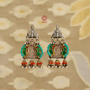 Noori two tone handcrafted earrings in 92.5 sterling silver with dual tones. Eclectic mix of elements with beautiful bird motifs, turquoise and semi precious stones and beads. Style this up with your favourite ethnic or fusion outfit.