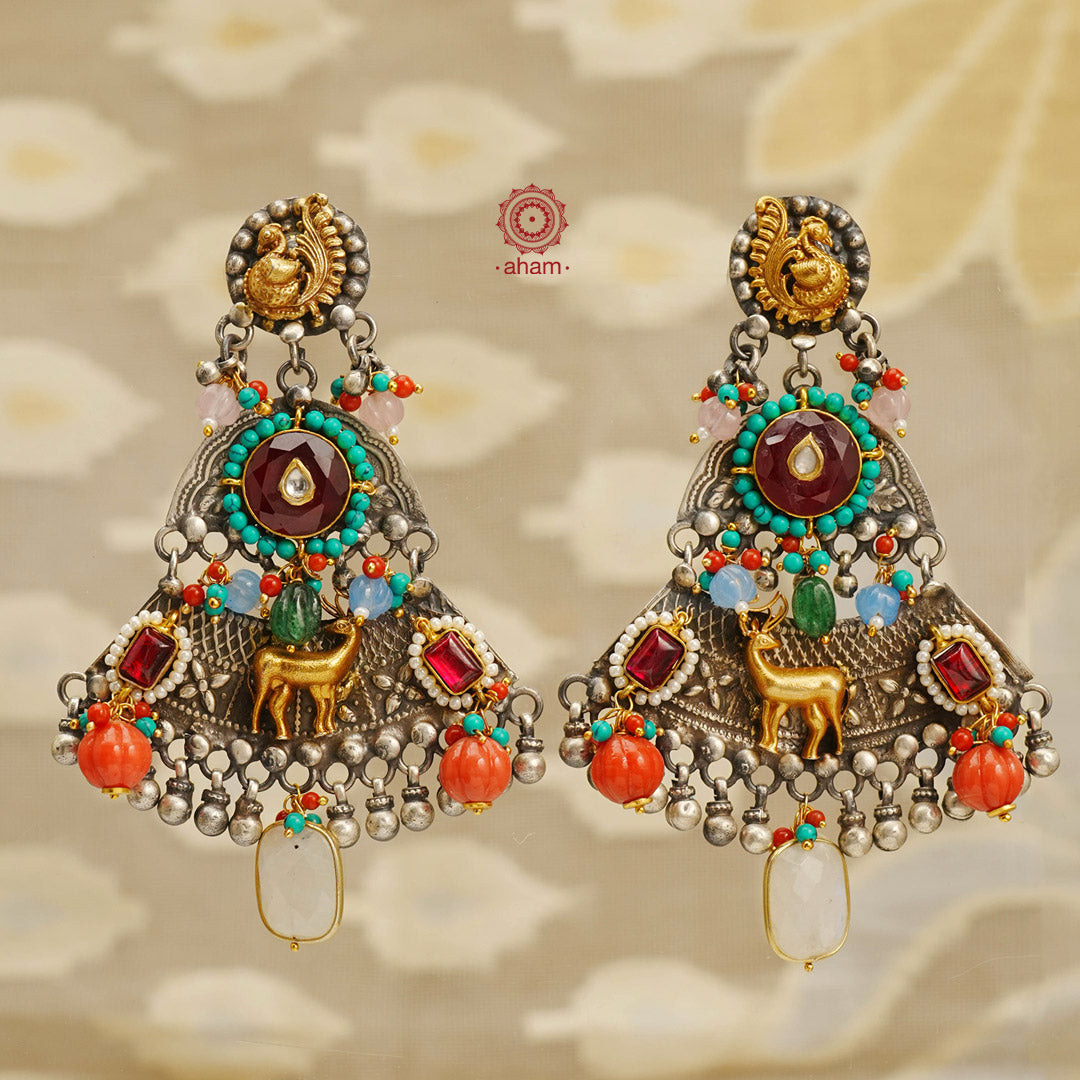 Noori two tone handcrafted earrings in 92.5 sterling silver with dual tones. Eclectic mix of elements with beautiful peacock & deer motifs, turquoise, pearl and semi precious stones. Style this up with your favourite ethnic or fusion outfit.