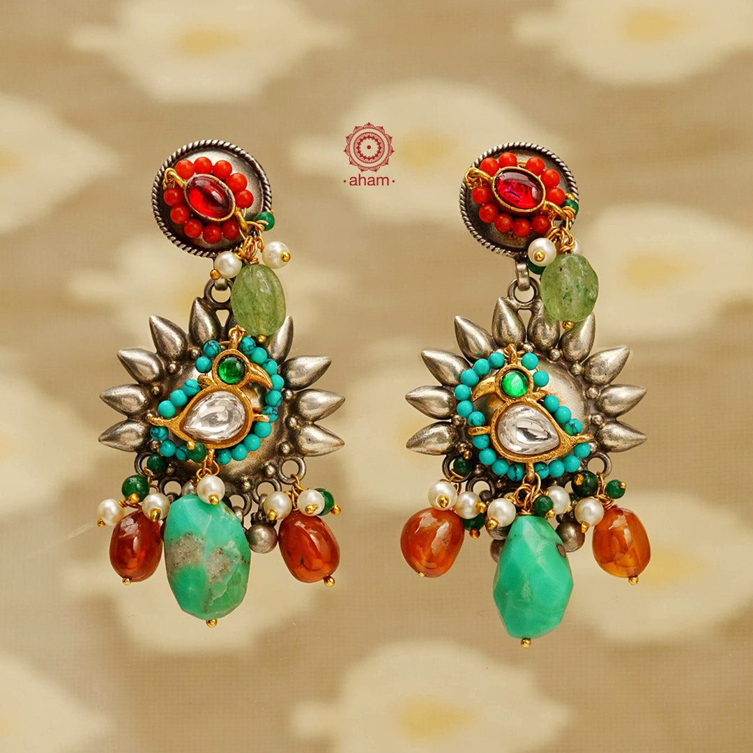Noori two tone handcrafted earrings in 92.5 sterling silver with dual tones. Eclectic mix of elements with beautiful motifs and semi precious stones. Style this up with your favourite ethnic or fusion outfit.