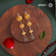 Enhance your style with the timeless elegance of the Dual Tone Silver Earrings. Handcrafted by skilled karigars in Barmer, Rajasthan, this earring features traditional Bandhel work, where a thin sheet of hand beaten 22 carat gold is set on 92.5 silver using a unique wax filling technique. A classic representation of Indian craftsmanship.