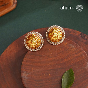 Enhance your style with the timeless elegance of the Dual Tone Silver Earrings. Handcrafted by skilled karigars in Barmer, Rajasthan, this earring features traditional Bandhel work, where a thin sheet of hand beaten 22 carat gold is set on 92.5 silver using a unique wax filling technique. A classic representation of Indian craftsmanship.