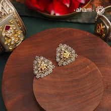 These Noori Two Tone Silver Studs add a touch of elegance to any occasion. Made from 92.5 silver with sparkling zircon settings and intricate rava work, these beautiful studs are the perfect accessory for parties. Elevate your look with these stylish and refined studs.