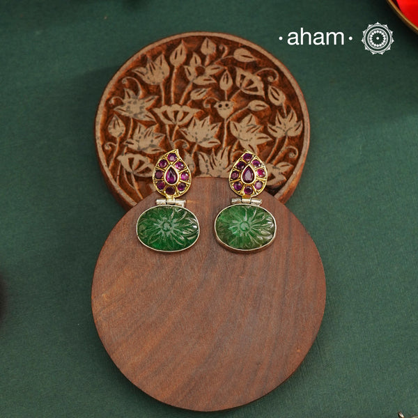 These Noori Two Tone Silver Earrings are expertly handcrafted from 92.5 sterling silver, showcasing traditional South Indian artistry. Featuring a delicately carved green stone, they add a refined touch to both ethnic and fusion ensembles. Perfect for elevating your look with authentic craftsmanship and timeless elegance.