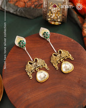 Noori Two Tone Double Swan Silver Earrings with quartz polki drop. The earrings are handcrafted in 92.5 sterling silver with gold highlights. Style this up with your favourite ethnic or fusion outfits to complete the look.