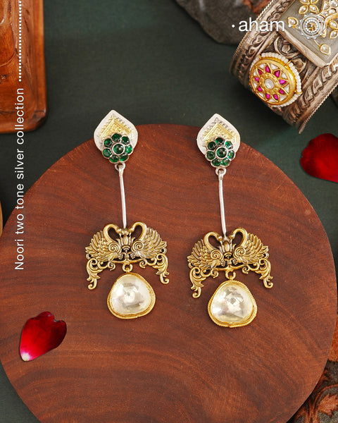 Noori Two Tone Double Swan Silver Earrings with quartz polki drop. The earrings are handcrafted in 92.5 sterling silver with gold highlights. Style this up with your favourite ethnic or fusion outfits to complete the look.