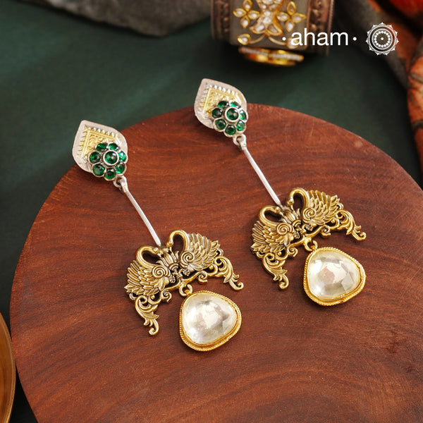 Noori Two Tone Double Swan Silver Earrings with quartz polki drop. The earrings are handcrafted in 92.5 sterling silver with gold highlights. Style this up with your favourite ethnic or fusion outfits to complete the look.