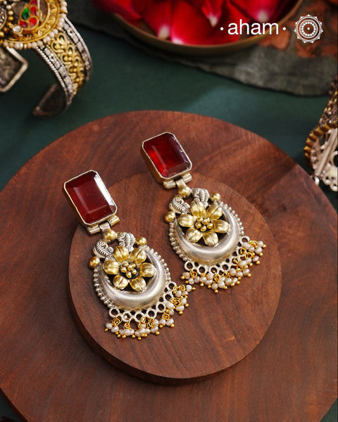 Noori two tone Earrings. The earrings are handcrafted in 92.5 sterling silver with gold highlights and a beautiful red stone feature. Style this up with your favourite ethnic or fusion outfits to complete the look.