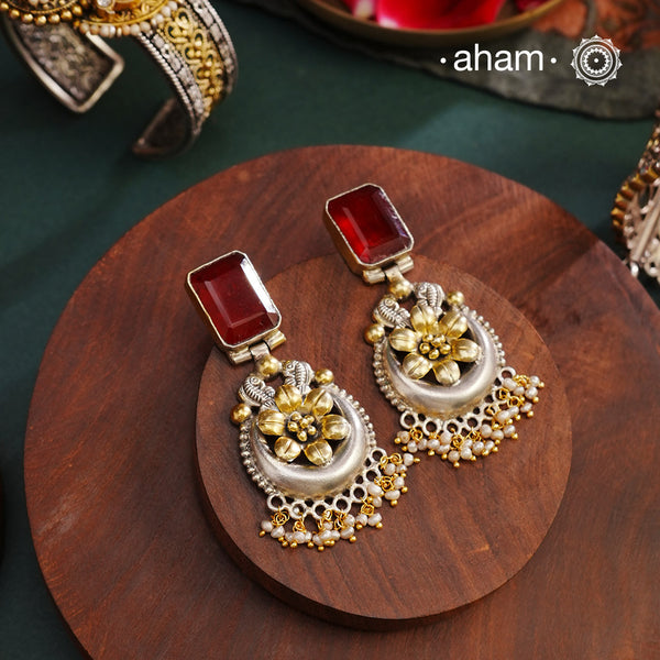 Noori two tone Earrings. The earrings are handcrafted in 92.5 sterling silver with gold highlights and a beautiful red stone feature. Style this up with your favourite ethnic or fusion outfits to complete the look.