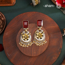 Noori two tone Earrings. The earrings are handcrafted in 92.5 sterling silver with gold highlights and a beautiful red stone feature. Style this up with your favourite ethnic or fusion outfits to complete the look.