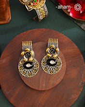 Noori two tone Earrings. The earrings are handcrafted in 92.5 sterling silver with gold highlights and a beautiful black onyx center. Style this up with your favourite ethnic or fusion outfits to complete the look.
