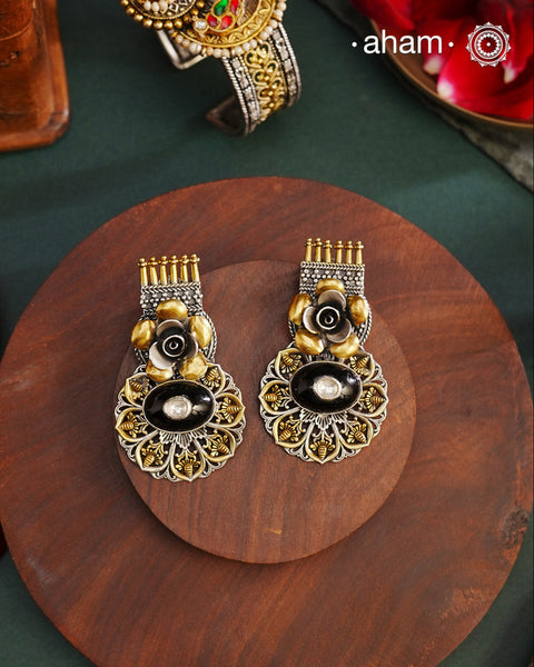 Noori two tone Earrings. The earrings are handcrafted in 92.5 sterling silver with gold highlights and a beautiful black onyx center. Style this up with your favourite ethnic or fusion outfits to complete the look.