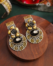 Noori two tone Earrings. The earrings are handcrafted in 92.5 sterling silver with gold highlights and a beautiful black onyx center. Style this up with your favourite ethnic or fusion outfits to complete the look.