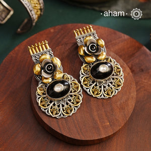 Noori two tone Earrings. The earrings are handcrafted in 92.5 sterling silver with gold highlights and a beautiful black onyx center. Style this up with your favourite ethnic or fusion outfits to complete the look.