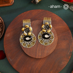 Noori two tone Earrings. The earrings are handcrafted in 92.5 sterling silver with gold highlights and a beautiful black onyx center. Style this up with your favourite ethnic or fusion outfits to complete the look.