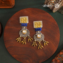 Noori Two Tone Peacock Silver Earrings. The earrings are handcrafted in 92.5 sterling silver with gold highlights.Style this up with your favourite ethnic or fusion outfits to complete the look.